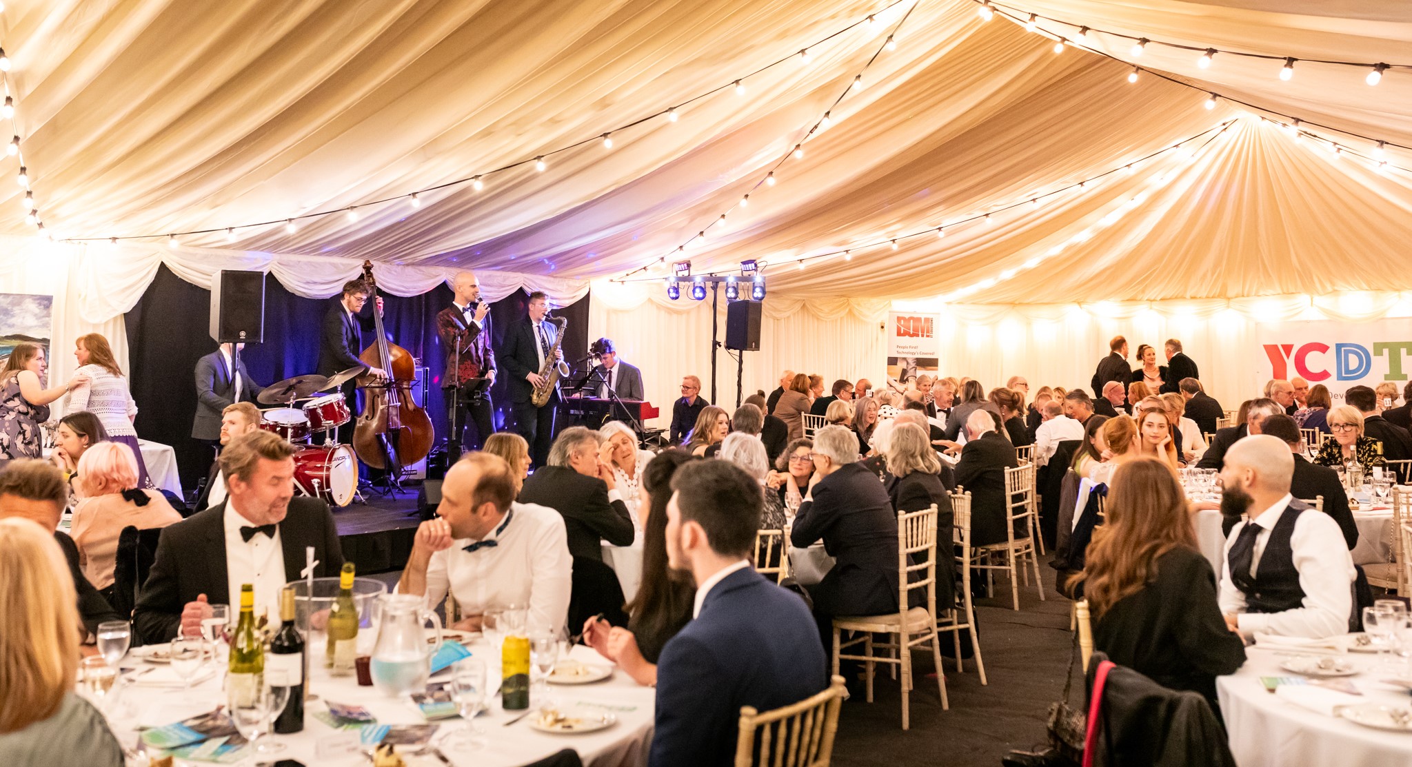 Guests at the gala dinner in front of performing jazz band